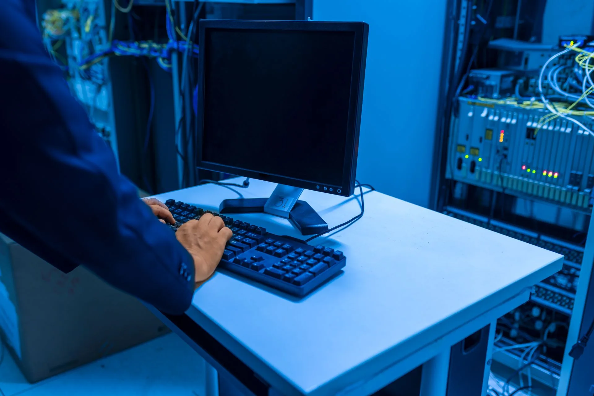 Cape Tech IT professional managing network systems in a server room