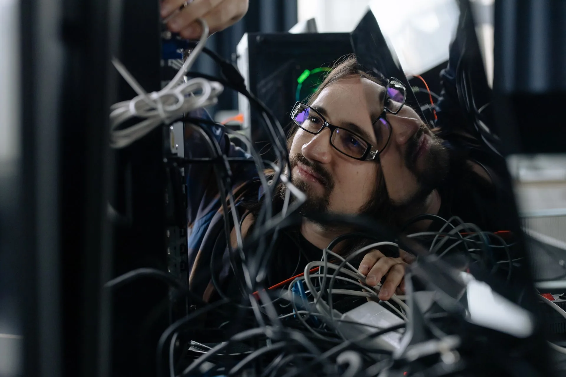 Cape Tech technician organising network cabling at a workstation