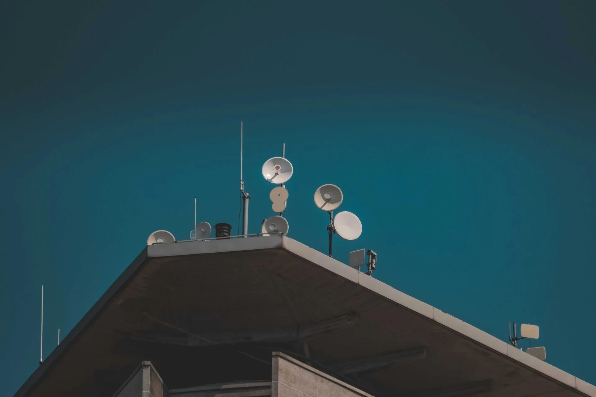 Telecommunication antennas and communication dishes mounted on a building